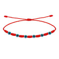 Pulsera roja de 7 nudos con siete amuletos de Ojo Turco y cordón ajustable.
