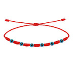 Pulsera roja de 7 nudos con siete amuletos de Ojo Turco y cordón ajustable.