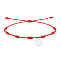 Pulsera de hilo rojo 7 nudos con charm minimalista de silueta calada de la Virgen de la Fuensanta en acero plateado