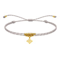 Pulsera Hilo Encerado con Colgante Nudo de Bruja en Acero Dorado